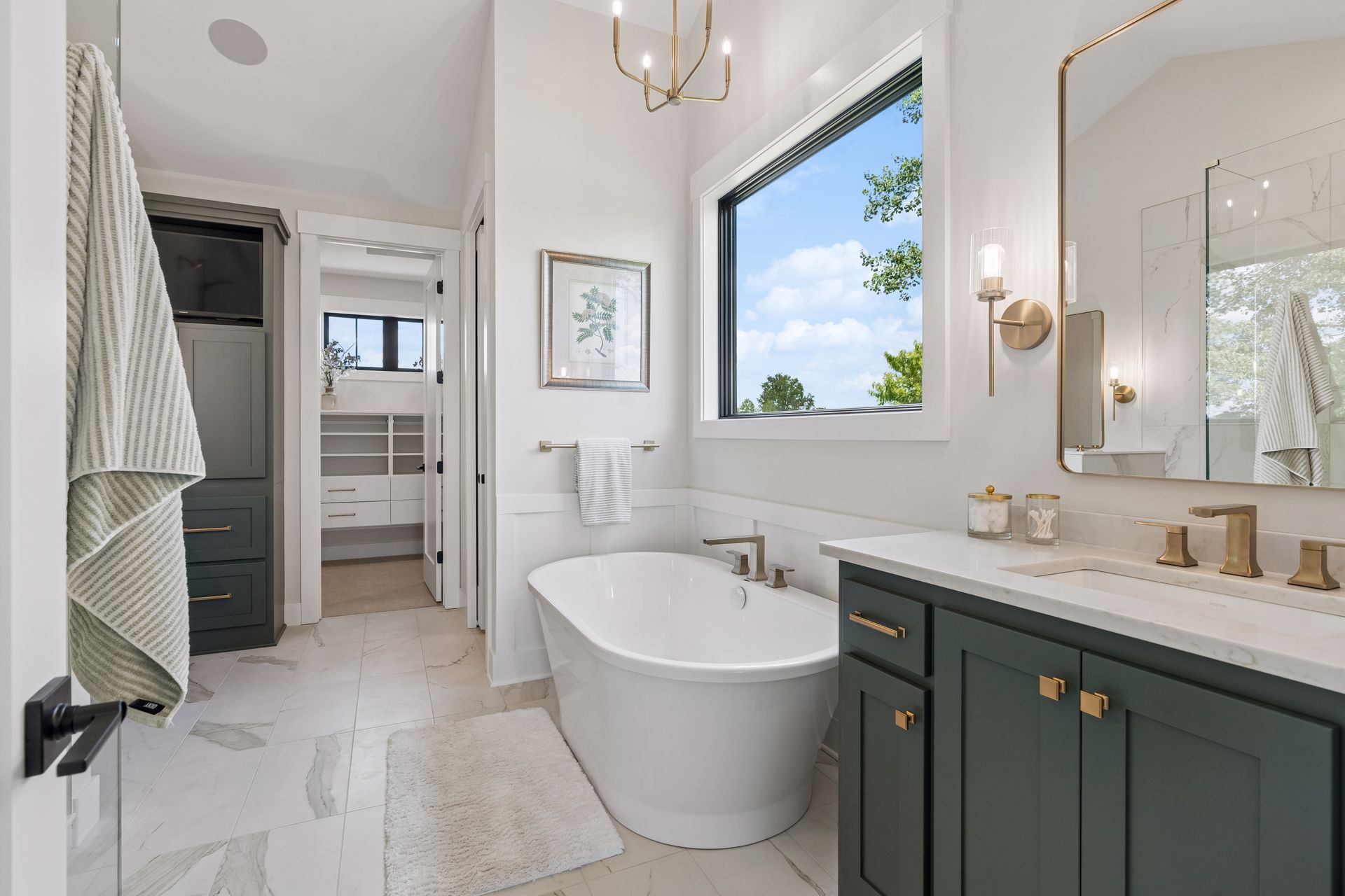 Luxury primary bathroom with freestanding soaking tub and custom vanity